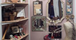 Vintage mirrors, artwork, baskets, and decorative items displayed inside Bliss Marketplace.